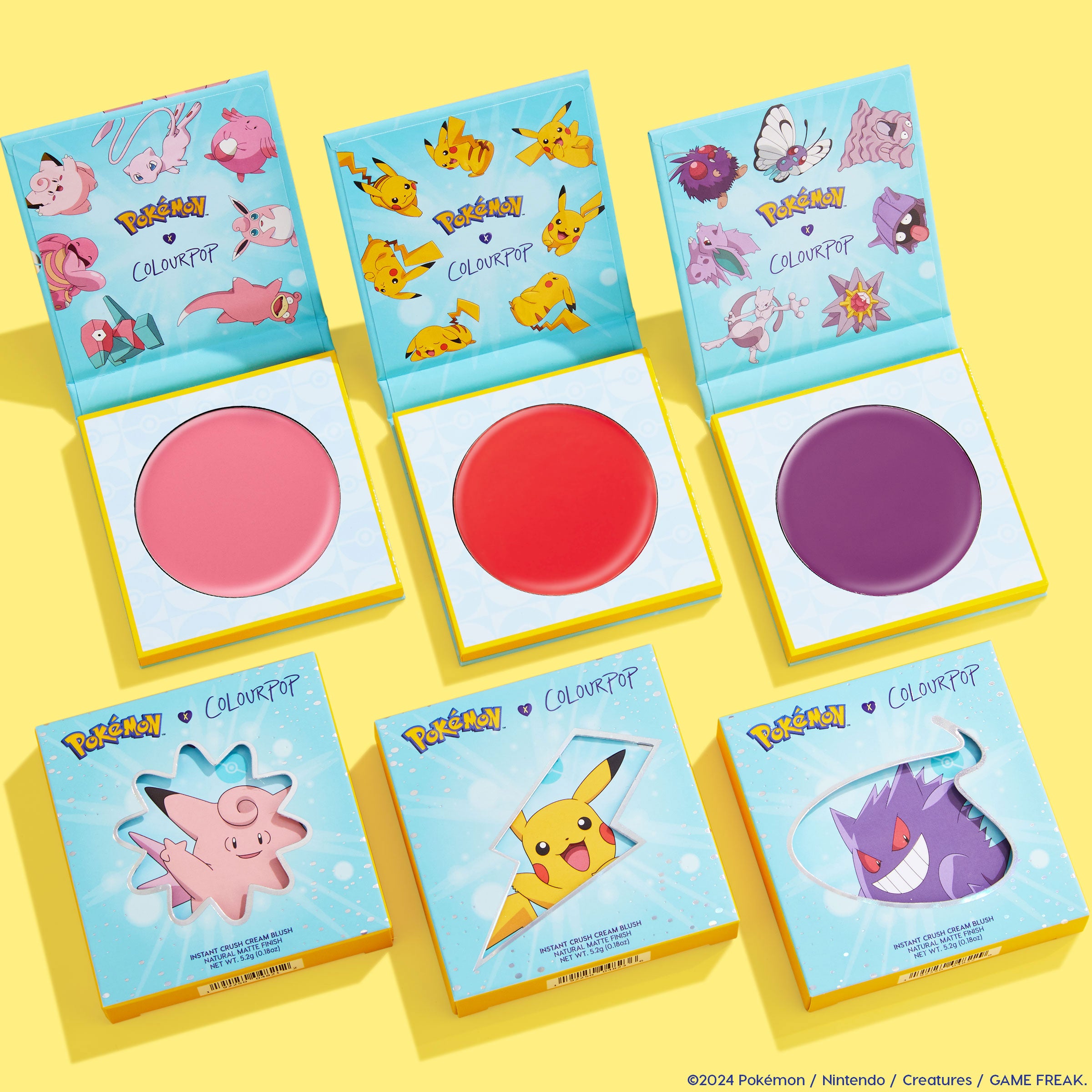 Electrifying Dreams ColourPop Cream Blush set presenting three open pans - soft pink, bright red, and deep purple - inside teal Pokémon-themed compacts, with matching boxes showing Clefairy, Pikachu, and Gengar on a bright yellow background.
