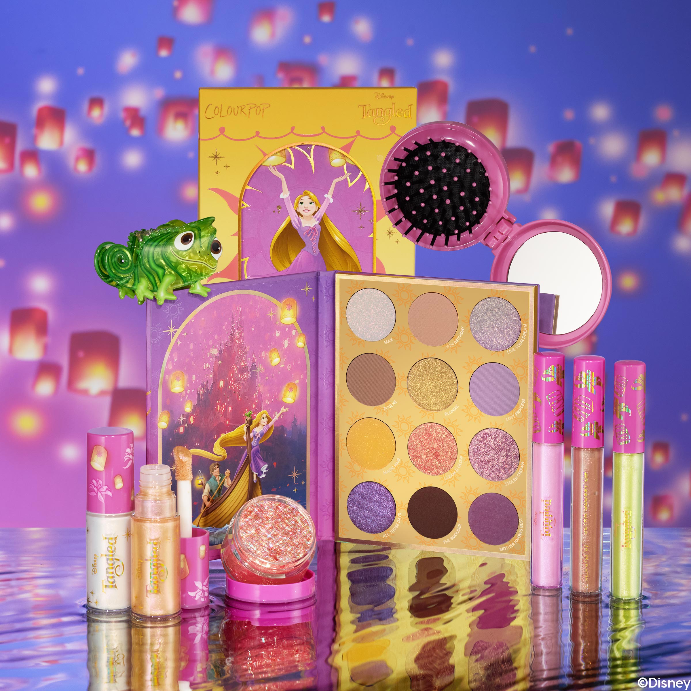 Disney Tangled and ColourPop Collection full set featuring Rapunzel-themed eyeshadow palette, lip glosses, highlighters, compact brush and mirror, and Pascal figurine arranged on reflective water-like surface with glowing lantern background, Back In Stock at ColourPop.