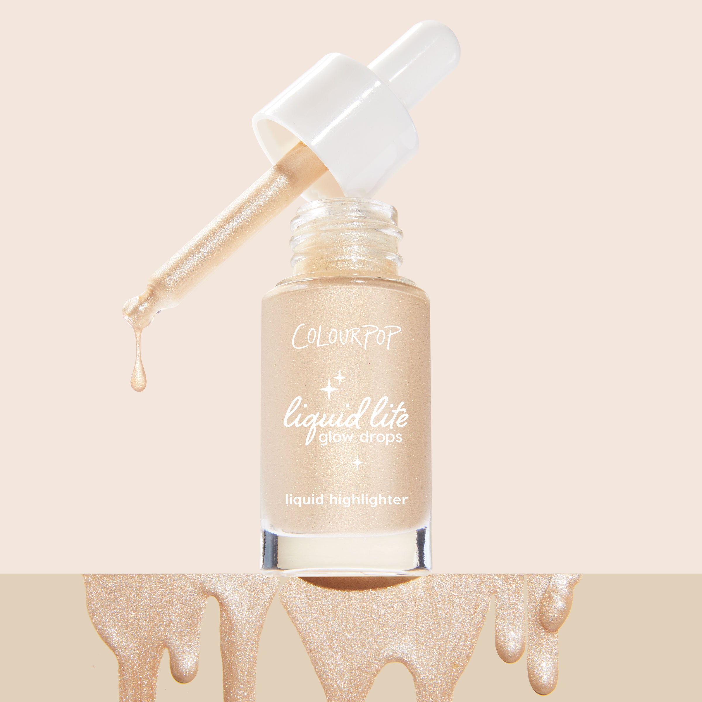 Sun O' Clock ColourPop Liquid Highlighter (Liquid Lite Glow Drops) in a frosted glass bottle, white dropper releasing a shimmering champagne drop, set against a soft beige backdrop with metallic glow drips along the bottom.