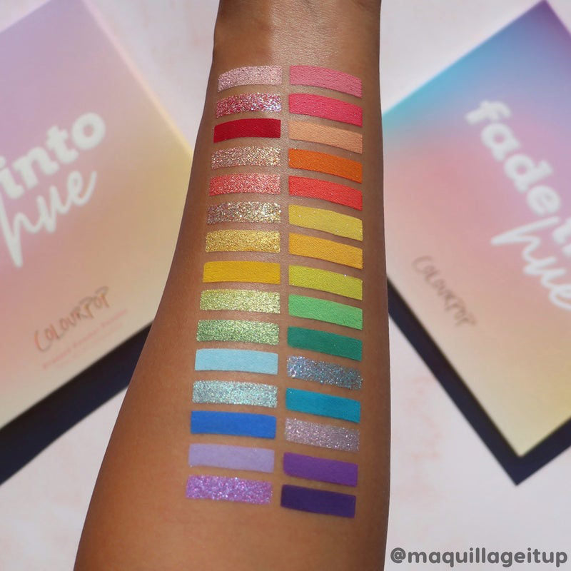 Fade Into Hue ColourPop Shadow Palette swatches - two rows of rainbow shades from pinks, reds, oranges, yellows, greens, blues to purples, in matte and glitter finishes - shown on a forearm with pastel gradient palette boxes in the background.