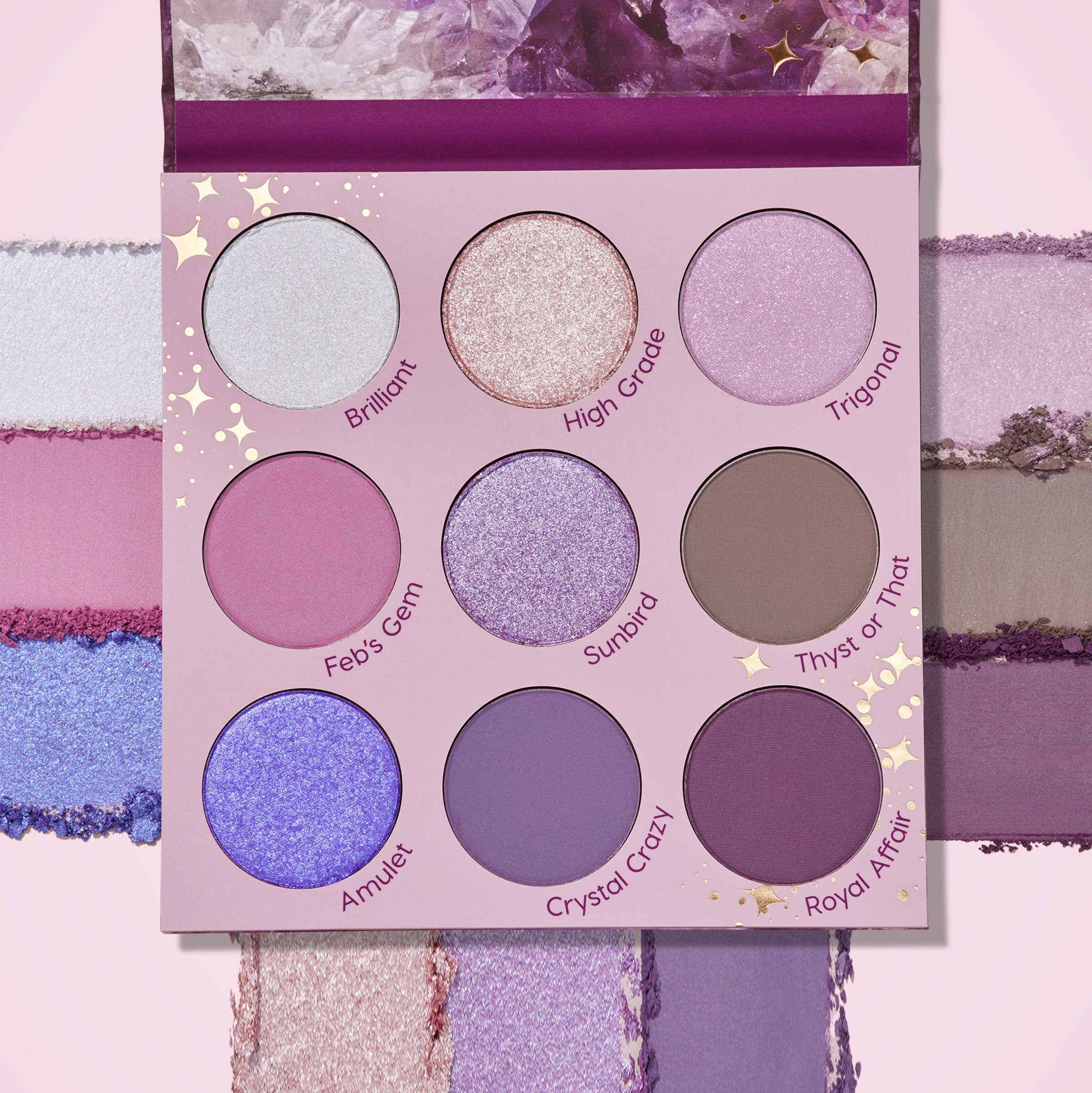 ColourPop All Amethyst shadow palette displays a 9-pan array of purple-toned shades - icy silver, lilac shimmers, taupe, and matte plums - with swatches framing the compact on a pink backdrop and an amethyst-print lid.