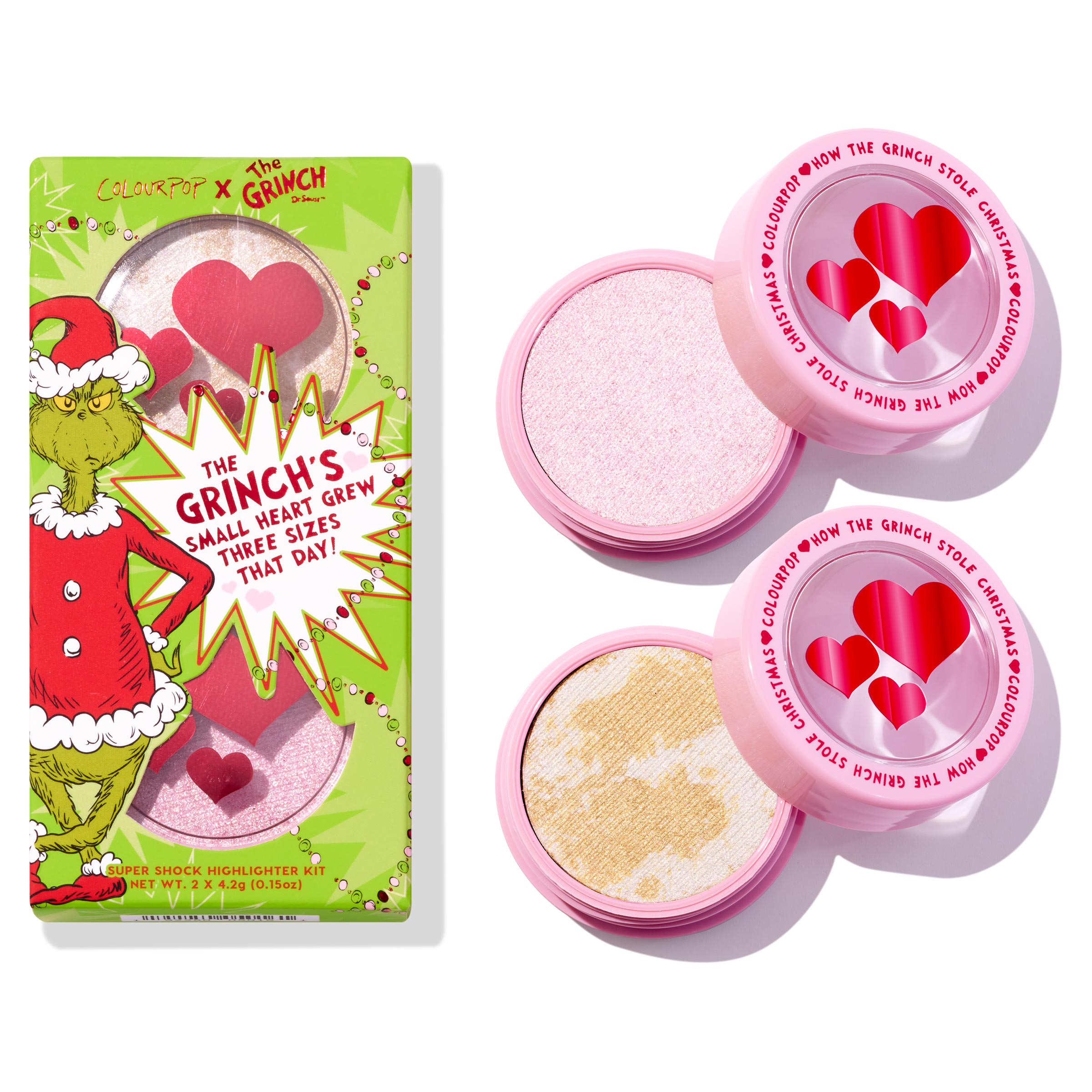 Change of Heart Super Shock Highlighter Kit by ColourPop x The Grinch, featuring two glow shades - icy pink and marbled gold - opened in pink pots with heart windows, set next to the bright green holiday box with the Grinch artwork.