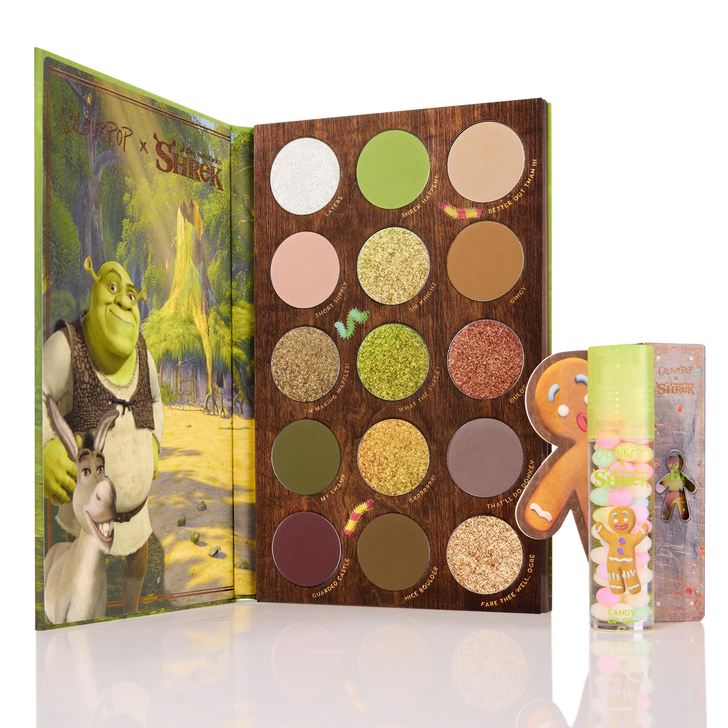 Shrek-Spress Yourself ColourPop Lip and Eye Set featuring an open 16-pan Shrek palette of greens, golds, and browns in matte and shimmer, plus a Candy lip oil with Gingy artwork; displayed upright on a clean white background.