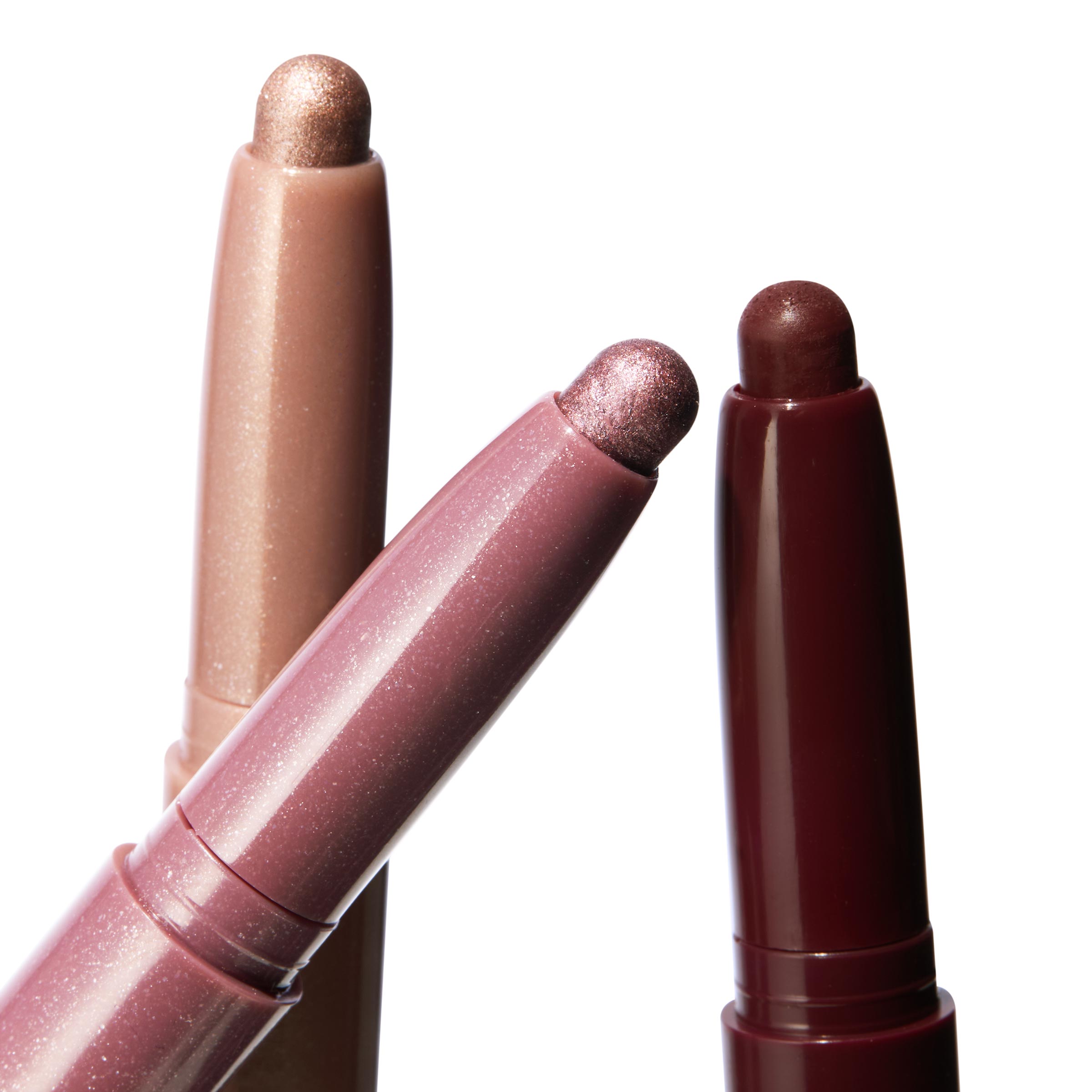 Rose Goals ColourPop Shadow Stix trio fanning out to display creamy shimmer tips in rose gold, metallic mauve, and deep burgundy, twist-up eyeshadow sticks shown in a close-up on a white background.