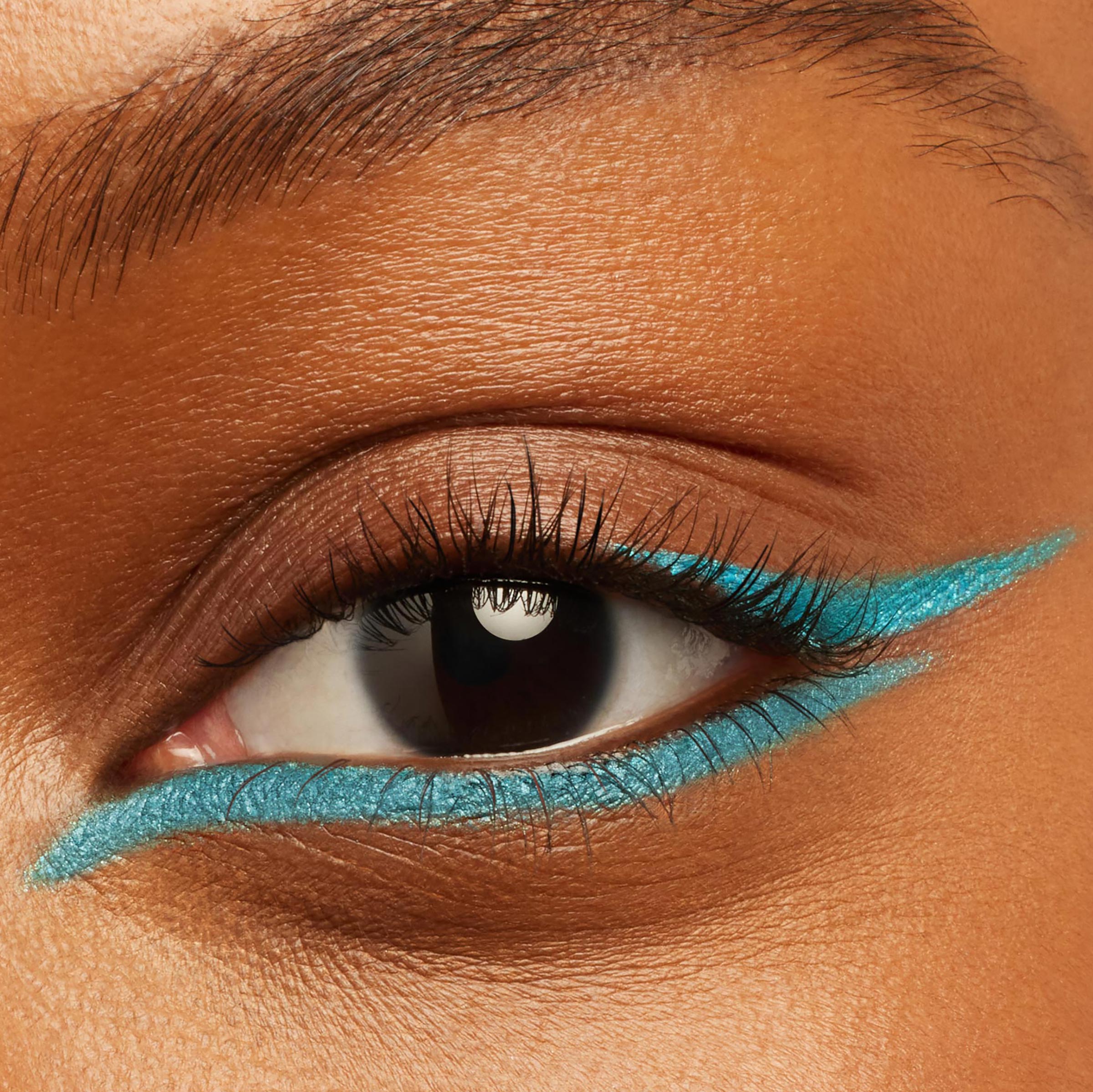 Shimmery turquoise double-wing liner defining upper and lower lash lines on a close-up eye, showcasing the creamy, precise payoff of ColourPop Crème Gel Liner in Crystal Crush for a sharp cat-eye finish.