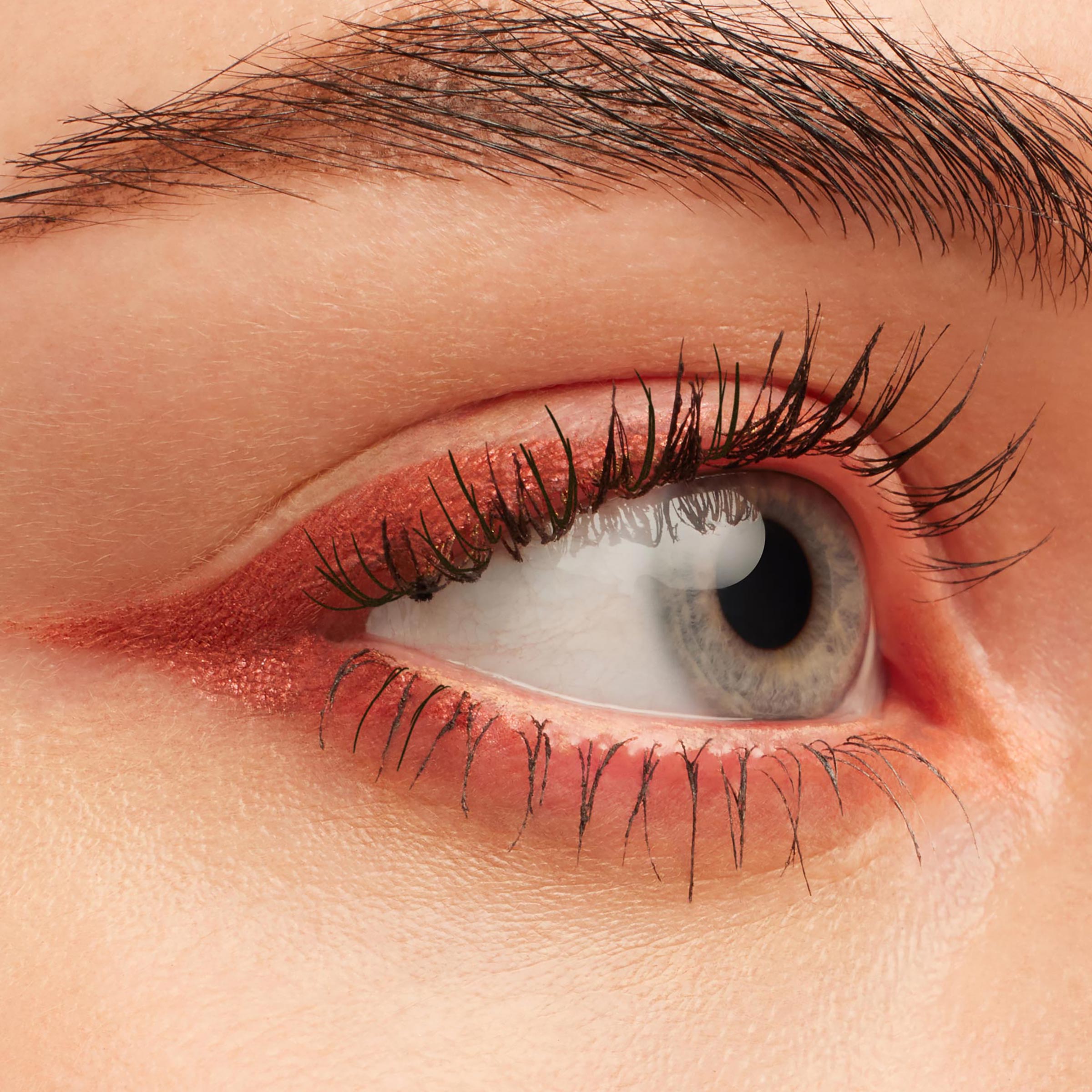 Eye showcasing Get Lucid, a metallic copper‑pink ColourPop Crème Gel Liner, swept along upper and lower lash lines with a soft inner-corner flick, emphasizing defined lashes in a clean close-up beauty shot.