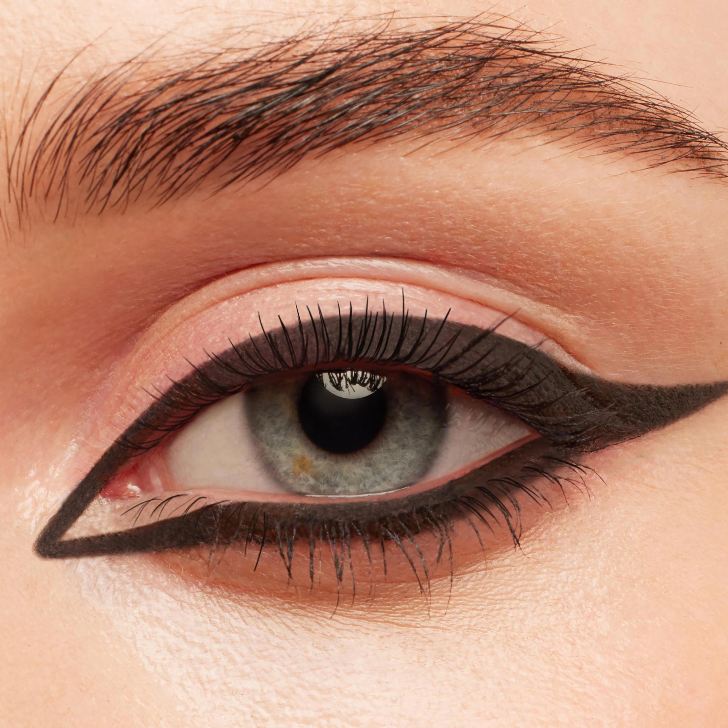 New BFF Crème Gel Liner tracing a bold, matte black graphic cat eye around a blue‑gray iris, with a precise inner corner point and extended wing, shown in a close-up of natural lashes and groomed brow; ColourPop TTS Exclusive.