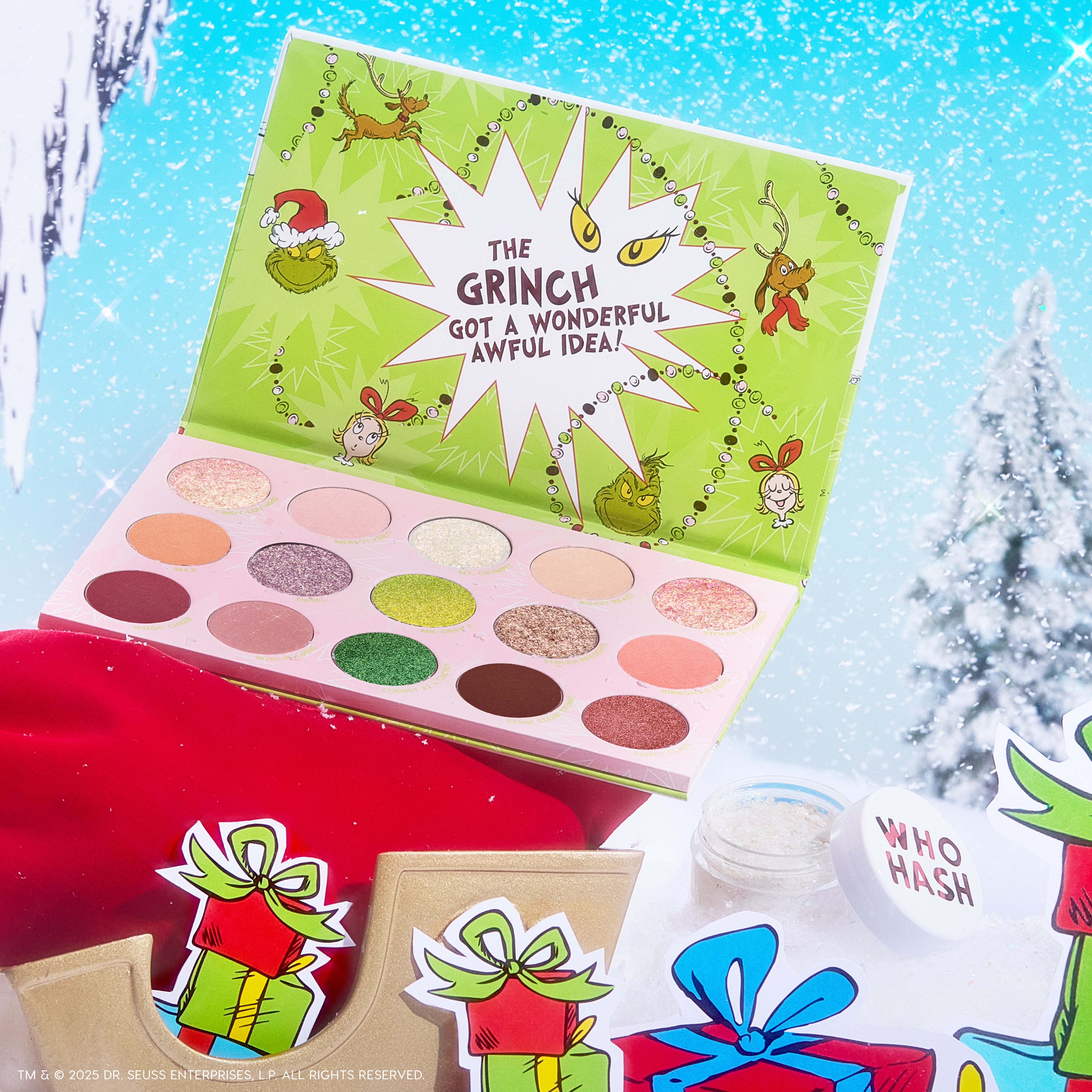Grinch Glam Shadow Palette + Glitter Gel by Colourpop, open to show 12 matte and shimmery shades - greens, neutrals, and coral - beside a WHO HASH glitter jar, staged with Grinch-themed gifts against a snowy holiday backdrop.