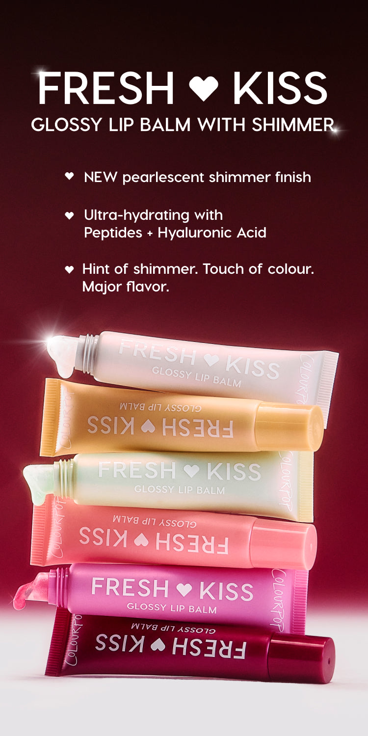 Stacked Colourpop Fresh Kiss Glossy Lip Balm tubes in shimmery pastel and berry shades rest on a deep red background, highlighting the pearlescent, ultra-hydrating lip balm with peptides, hyaluronic acid, and subtle color shimmer.
