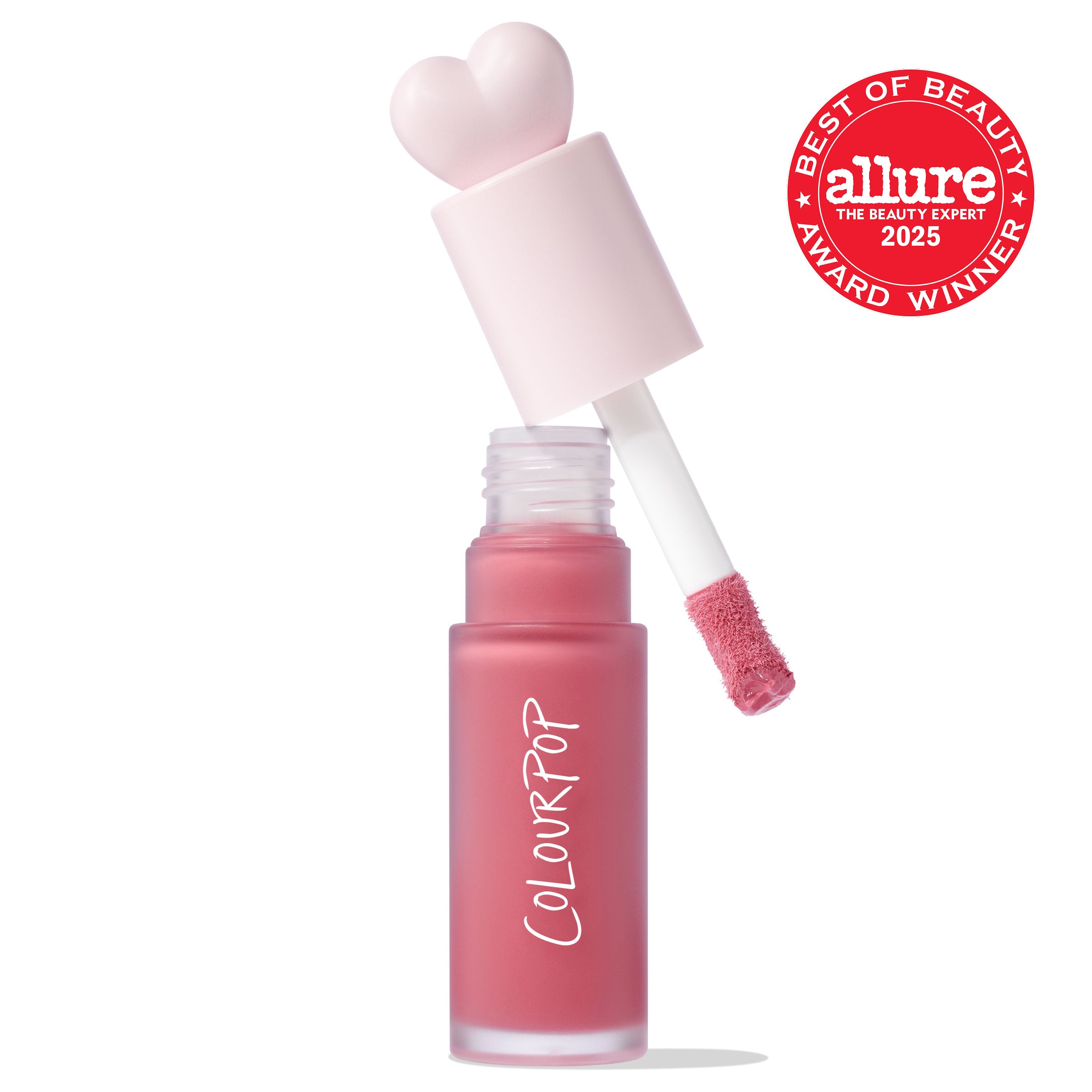 ColourPop Liquid Blush IKTR shown with cap off, doe-foot applicator coated in rosy pink formula hovering above a frosted glass tube with ColourPop logo, heart-shaped pastel pink cap, on white background, with Allure Best of Beauty 2025 award badge.
