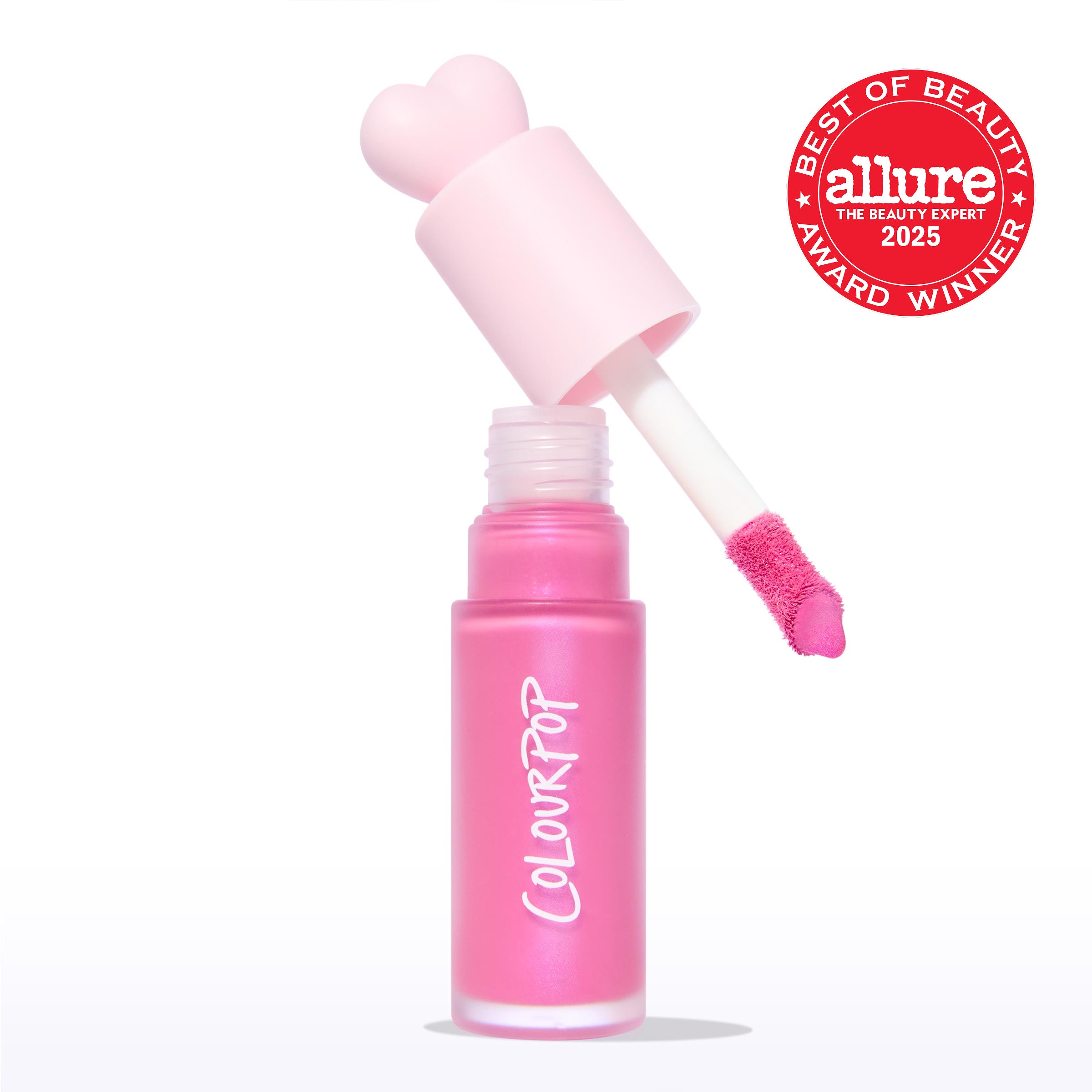 ColourPop Liquid Blush Sweet Treat shown open, doe-foot applicator lifting vivid pink pigment from a frosted pink bottle with a heart-shaped cap and ColourPop logo, on a white background beside an Allure Best of Beauty 2025 award badge.