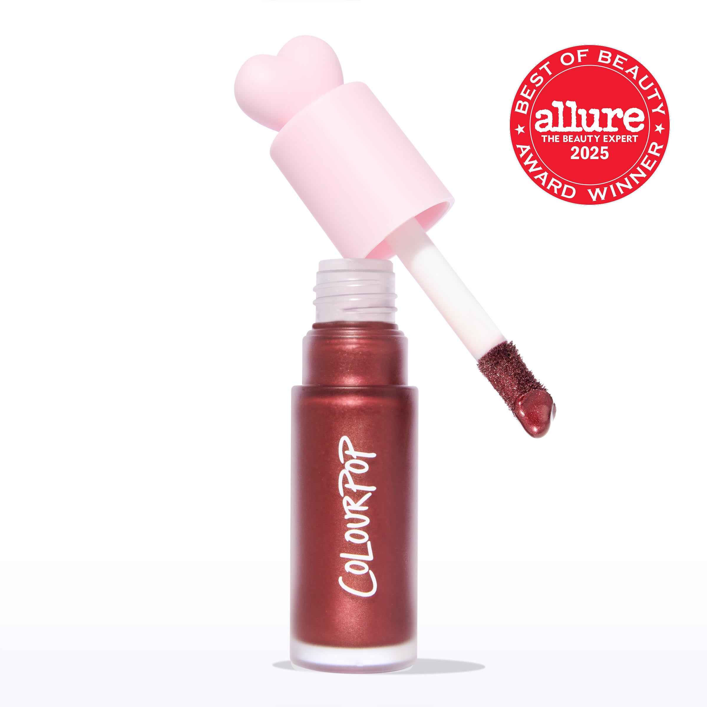 ColourPop Liquid Blush Wine n’ Dine dispenses from an open tube with a pink heart-shaped cap and doe-foot applicator coated in a deep wine, pearly blush, set on a white background with an Allure Best of Beauty 2025 award badge.