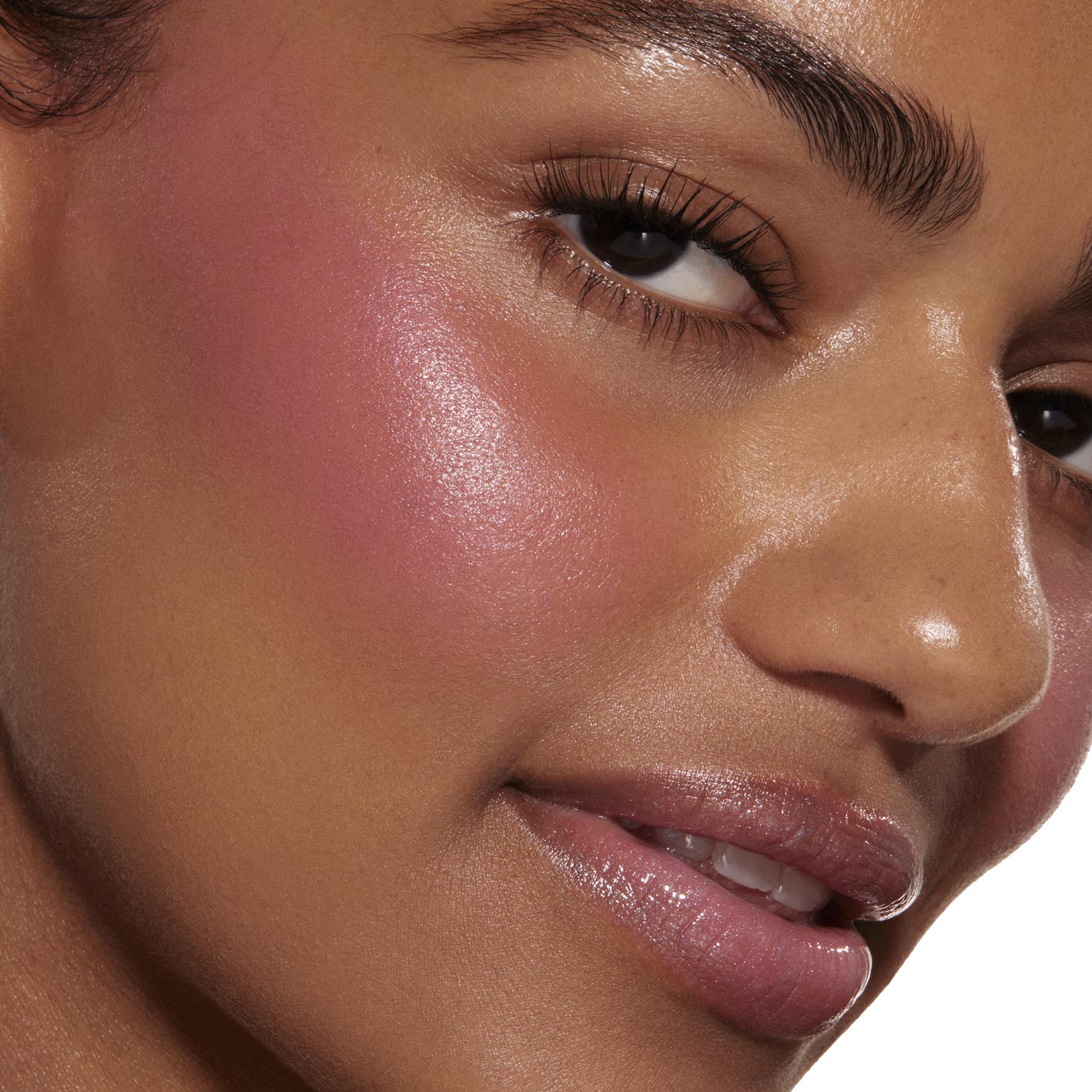 Sweet Treat ColourPop Liquid Blush tinting a model’s cheek with a dewy, luminous pink flush, seamlessly blended along the cheekbone; tight close-up shows smooth skin, glossy lips, and defined lashes for context.