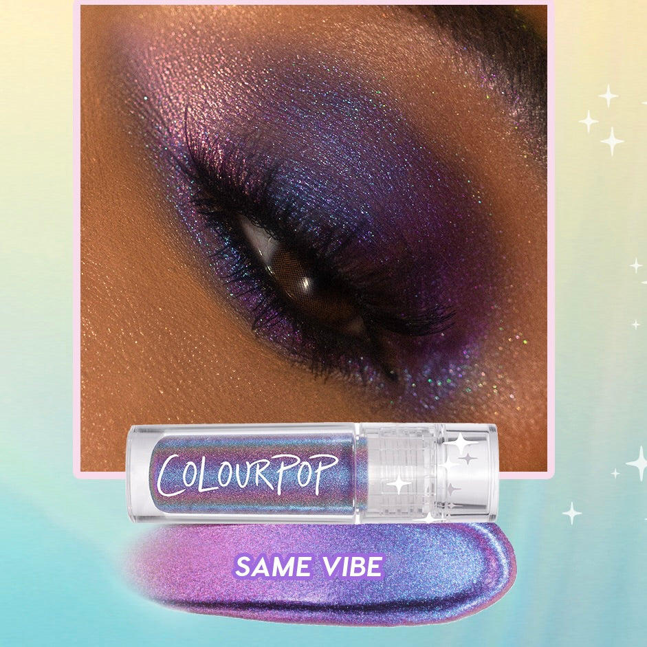ColourPop Chrome Liquid Shadow 'Same Vibe' delivers a vivid purple-to-blue multichrome finish - shown on a closed eyelid with sparkly, blended pigment; the clear tube and swatch sit below against a pastel gradient background.