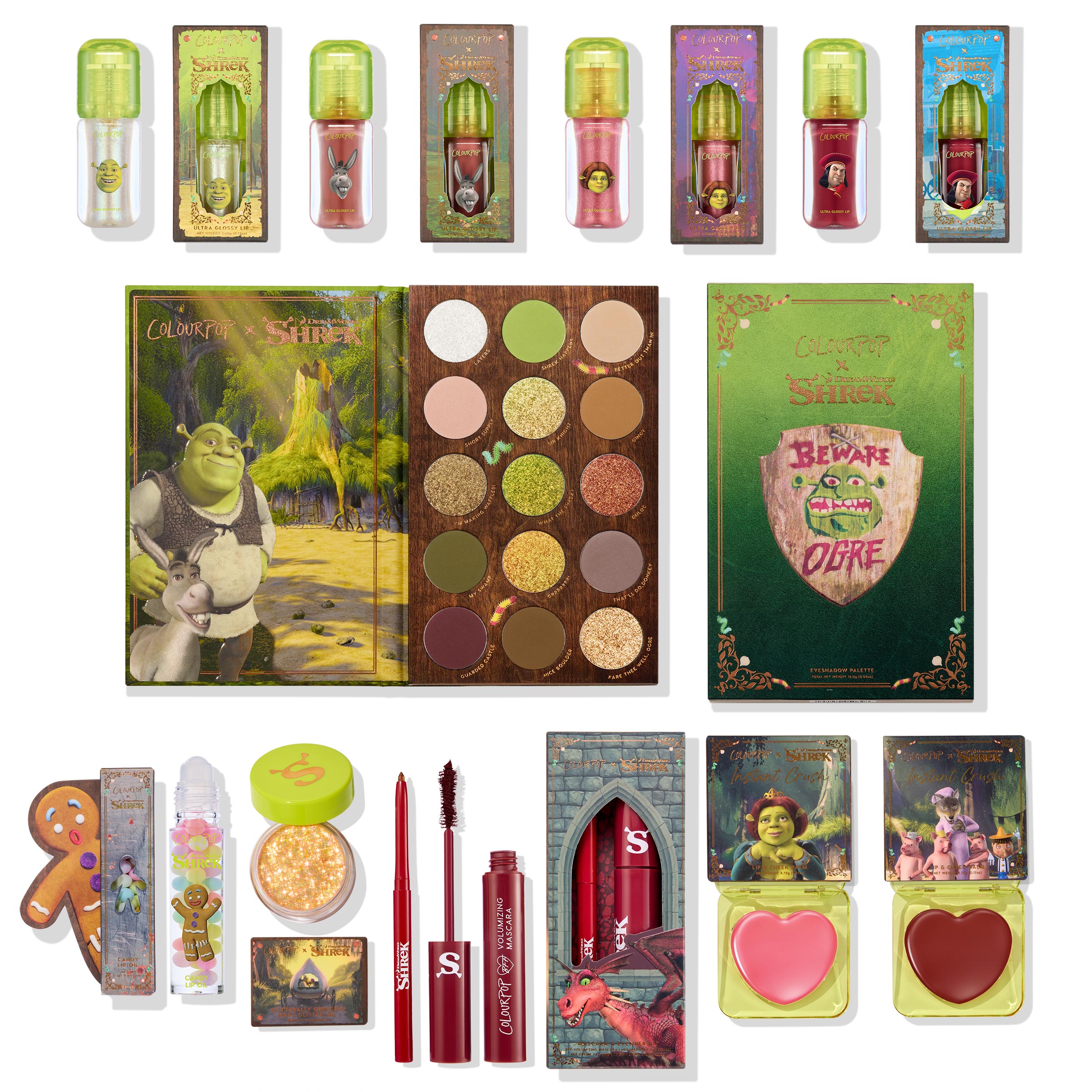 ColourPop X DreamWorks Shrek full collection set arranged in a flat lay: earthy eyeshadow palette, character lip oils and glosses, sparkle gel, red mascara and liner, and heart-shaped blush compacts with Shrek and Donkey artwork; ColourPop Full Collection Set.