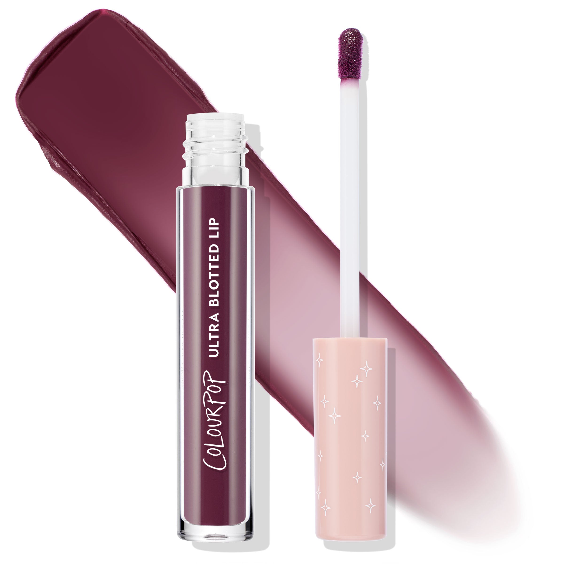 ColourPop Ultra Blotted Lip So Vintage shown open with doe-foot applicator and starry peach cap, clear tube with white logo, and a rich berry‑plum blotted matte swatch behind on a white background.