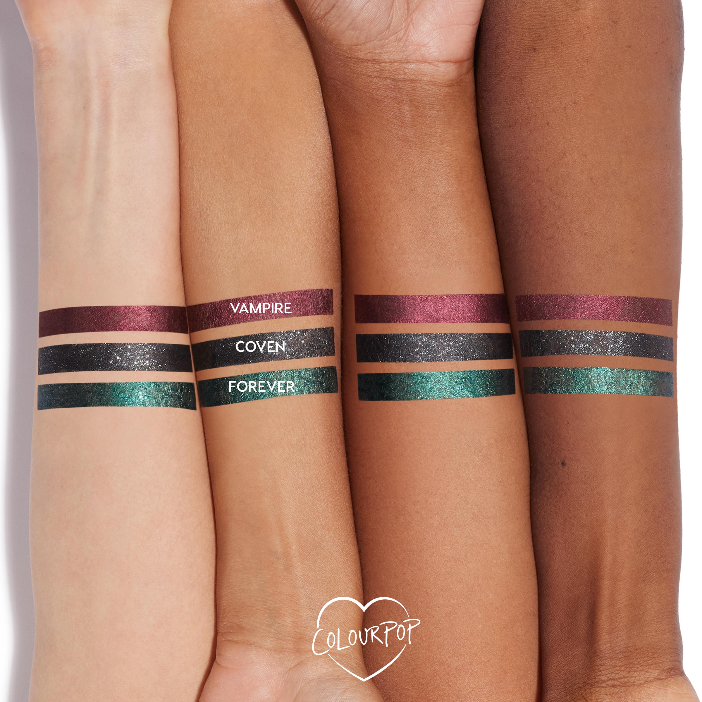 Forever shade of ColourPop Graphix Ink Liner swatched in bold metallic teal stripes on four arms of varying skin tones, shown with labeled companion shades Vampire (berry shimmer) and Coven (sparkly black) to showcase pigment, shine, and payoff.