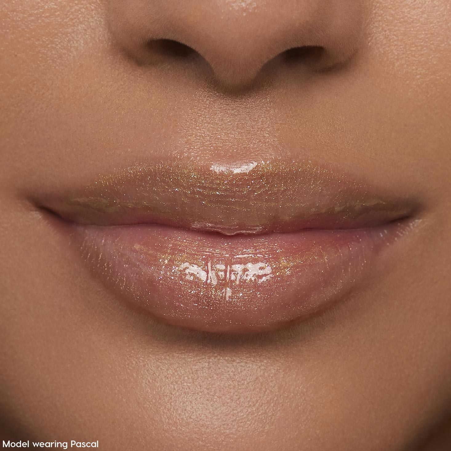 Lips wearing ColourPop Ultra Glossy Lip Pascal, catching studio light in a sheer, high-shine finish with fine iridescent shimmer; extreme close-up beauty shot emphasizing smooth, hydrated lips and glossy payoff.