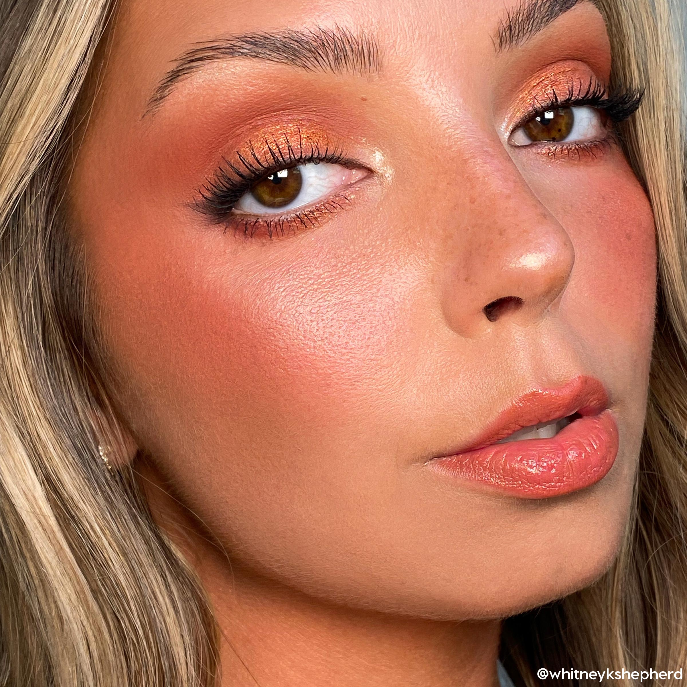 Rock On ColourPop Shadow Palette creating a copper shimmer eye on a model, blending warm terracotta in the crease with a bright inner-corner highlight, paired with long lashes, peach blush, and glossy nude lips in a studio close-up.