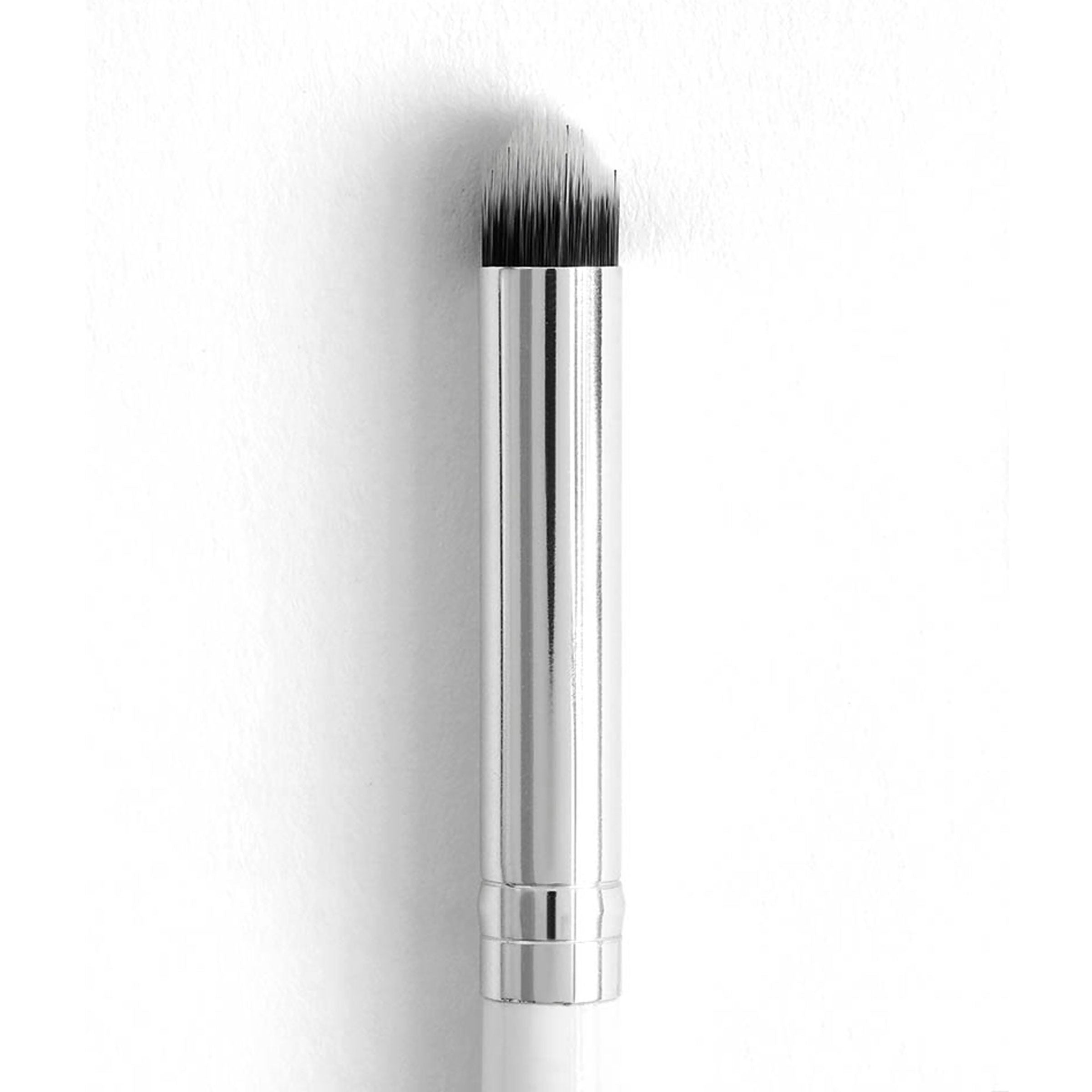 ColourPop Pencil Brush showcasing a tapered, densely packed tip with a chrome ferrule and slim white handle, positioned upright for precise eyeshadow smudging and detail work against a clean white background.