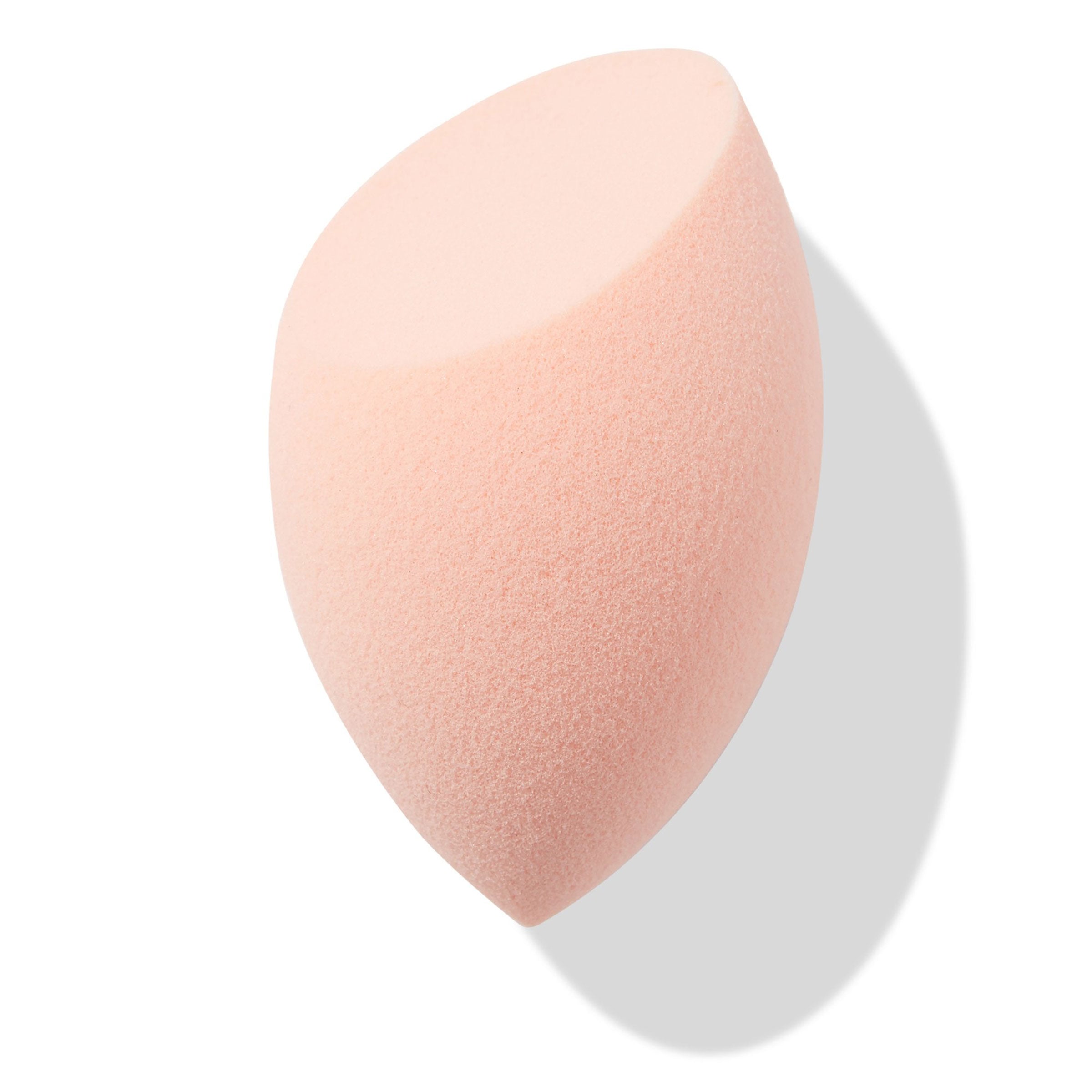 Peach teardrop Blending Sponge with a flat slanted edge resting at an angle, showing fine foam texture for seamless foundation and concealer blending, isolated on white with soft shadow; a must-have in ColourPop Makeup Tools & Accessories.