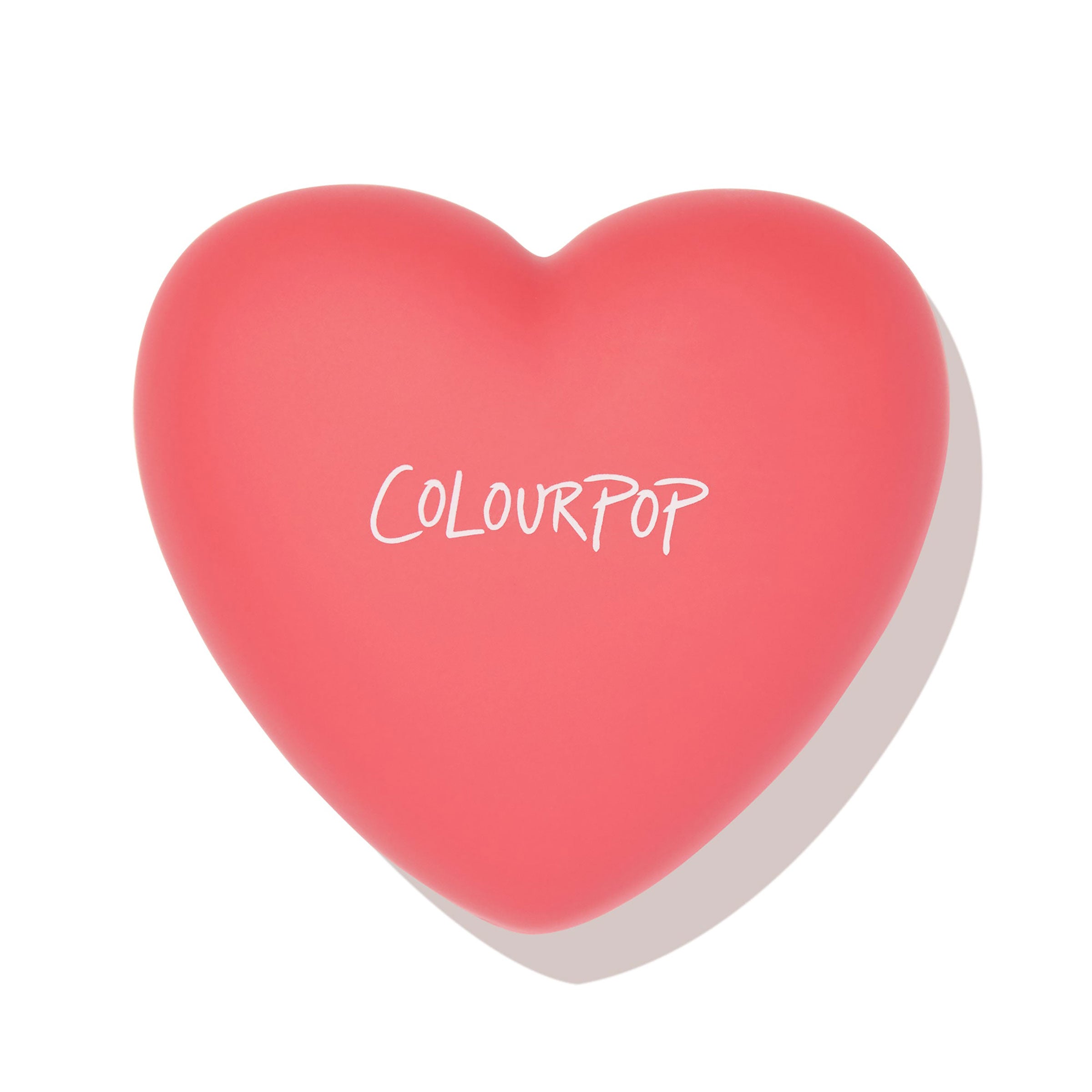 Heart-shaped coral pink compact with white ColourPop logo, closed and centered, showcasing 4ever Yours ColourPop Pressed Powder Blush packaging against a clean white background with a soft shadow.