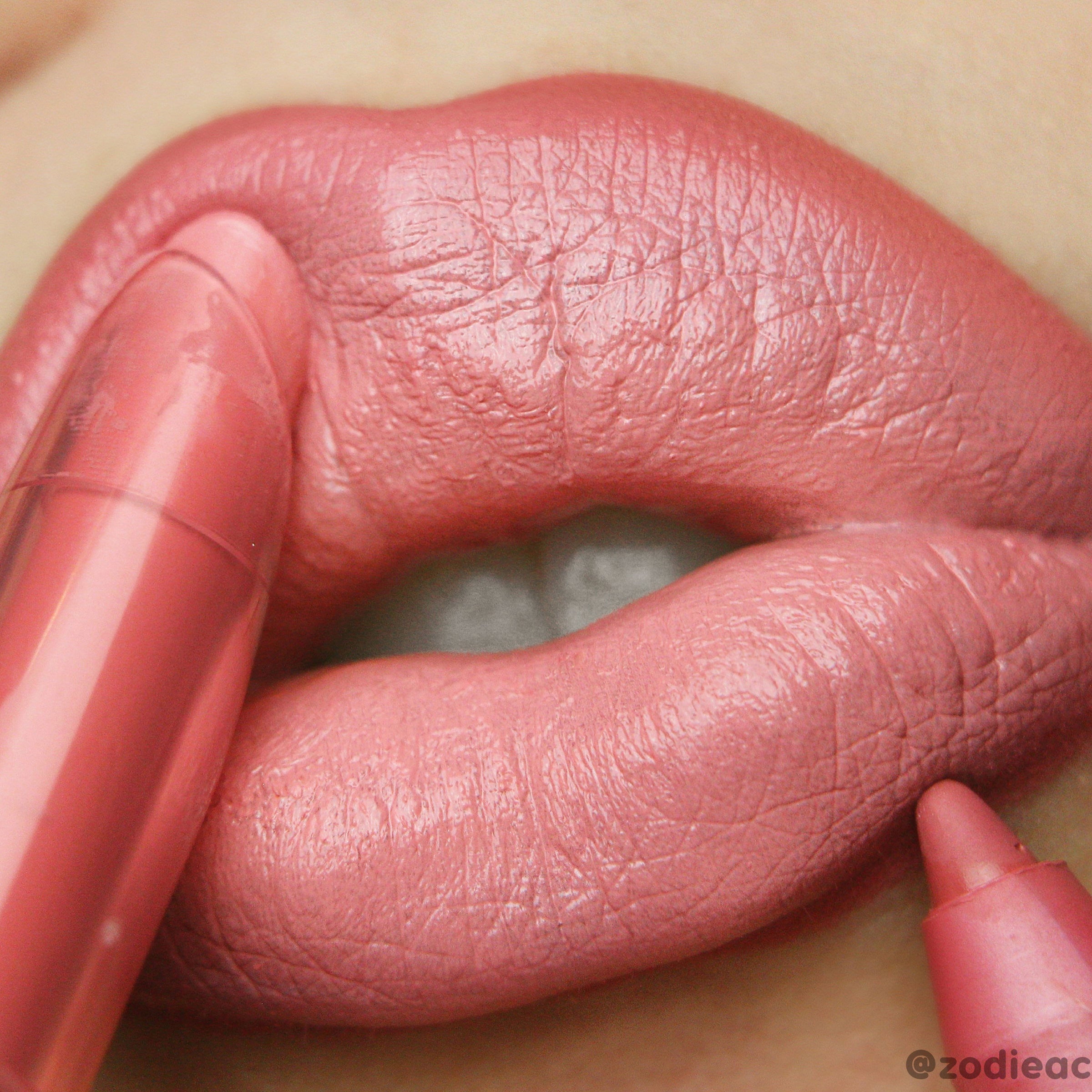 Caramella Lippie Stix gliding onto full lips, depositing a warm pink-coral creamy satin finish, as two ColourPop Lippie Stix bullets frame the mouth in an extreme close-up makeup swatch.
